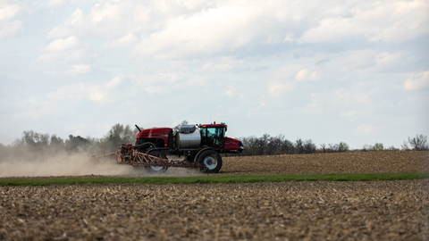 Case-IH self propelled sprayer spraying along a grassway.