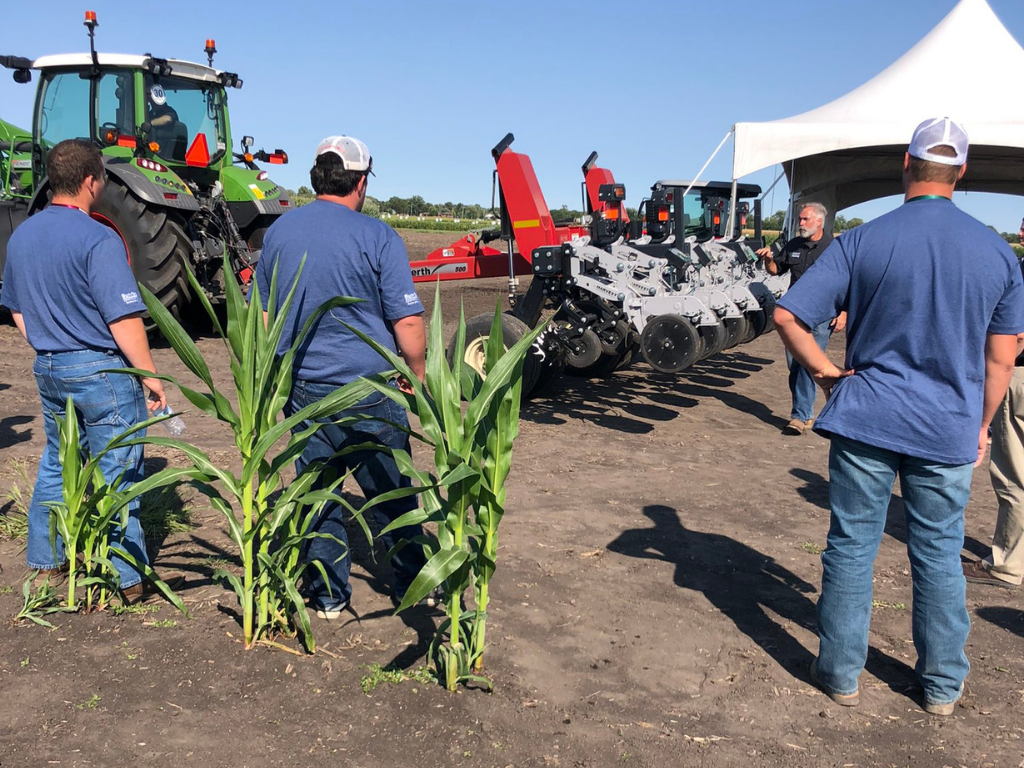 PTI Farm Tour visitors learn about Ready Row Unit from an agronomist.
