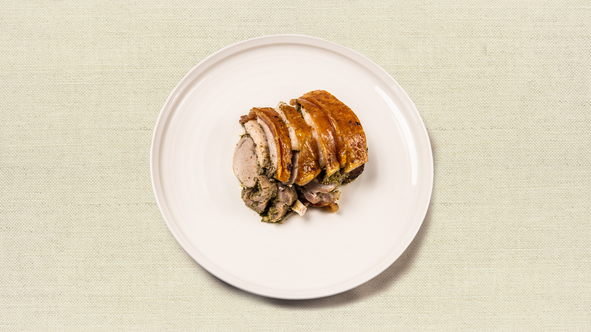 Crackling Pork Loin (gf) - Juicy pork loin with crackling, crunchy skin, slow roasted until rich and golden, served with your choice of sauce - our chef recommends the Peruvian garlic aji verde sauce. (12-14 oz, gluten free, serves 2-3)
