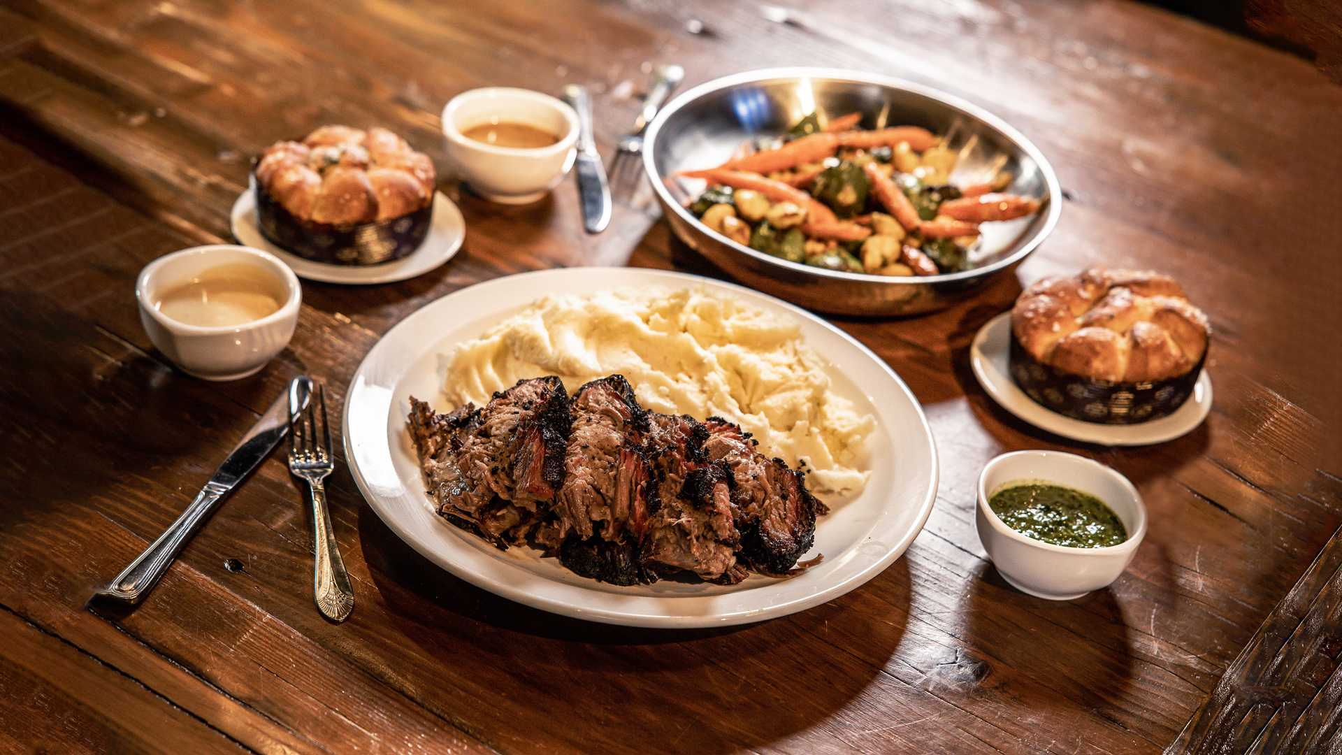 Smoky Beef Brisket Meal - Smoky, slow-cooked beef brisket (12-14 oz) served with creamy mashed potatoes, garlicky roasted veggies, and fluffy, pull apart Parker House rolls - choice of sauce (serves 2-3).