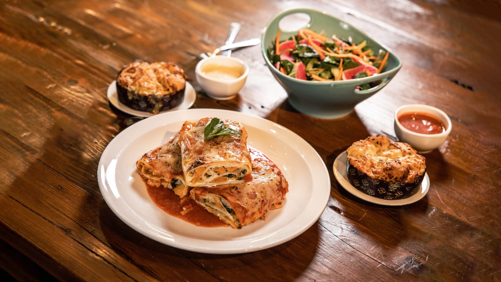 Mama’s Lasagna Meal - Hand-rolled lasagna (16 oz, meat or veggie) served with fresh greens salad with white balsamic vinaigrette and cheesy garlic monkey bread (serves 2-3).