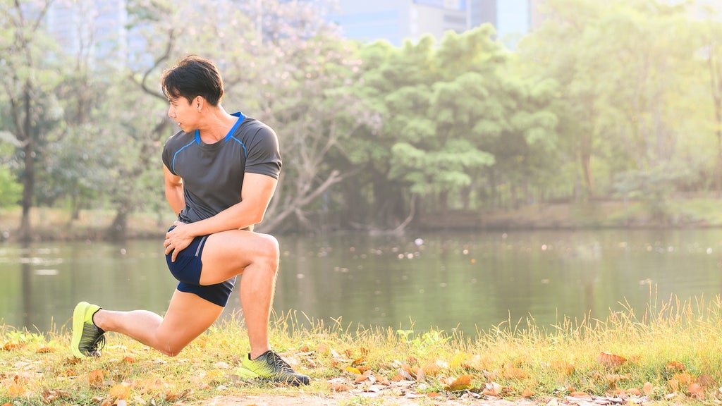 men stretching by a pond in the morning