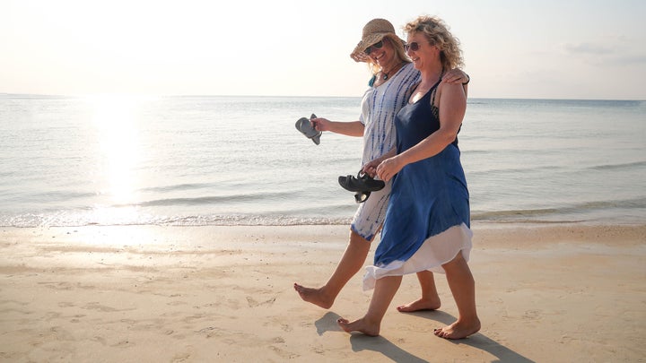 two friends walking on the beach