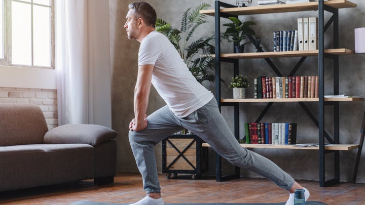 man stretching at home