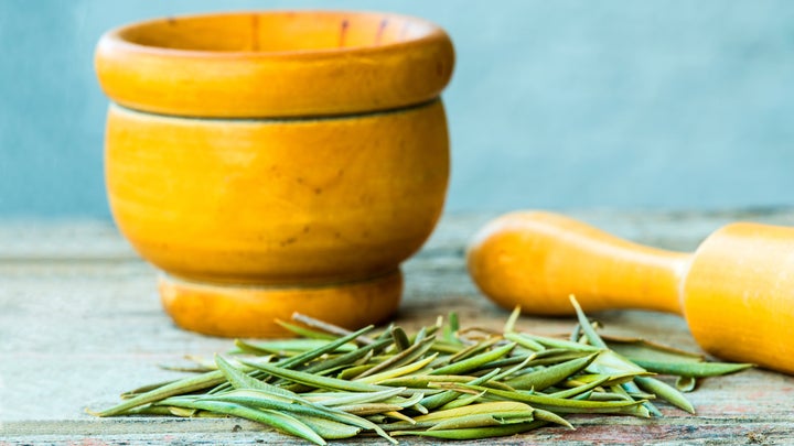 mortar and pestle wth olive tree leaves