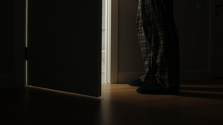 man going into the bathroom late at night