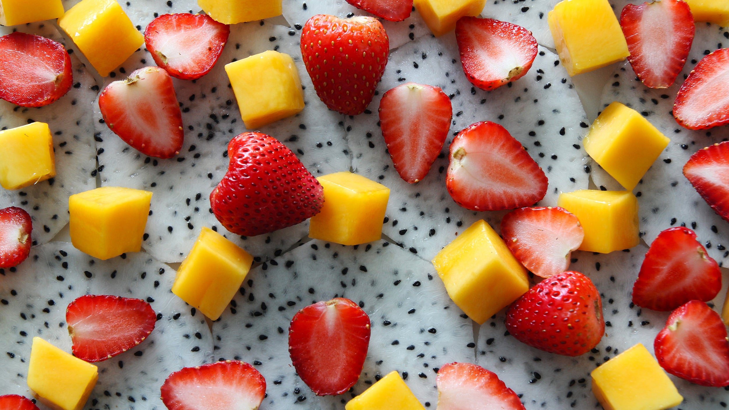 sliced and cubed strawberries and mango
