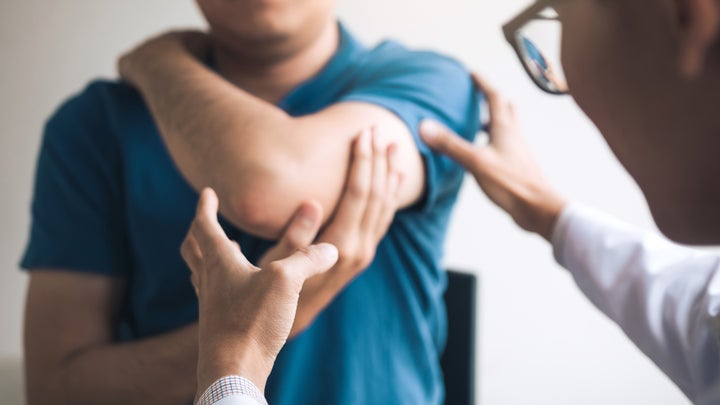 doctor checking the patient's elbow