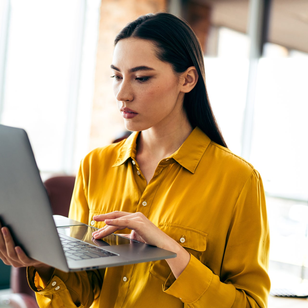 A real estate agent checking her laptop.