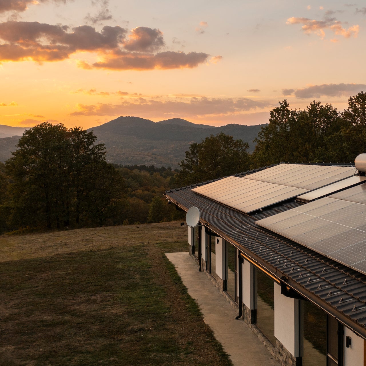Building with solar panels on its roof, suggesting the use of energy modeling for optimizing solar energy efficiency