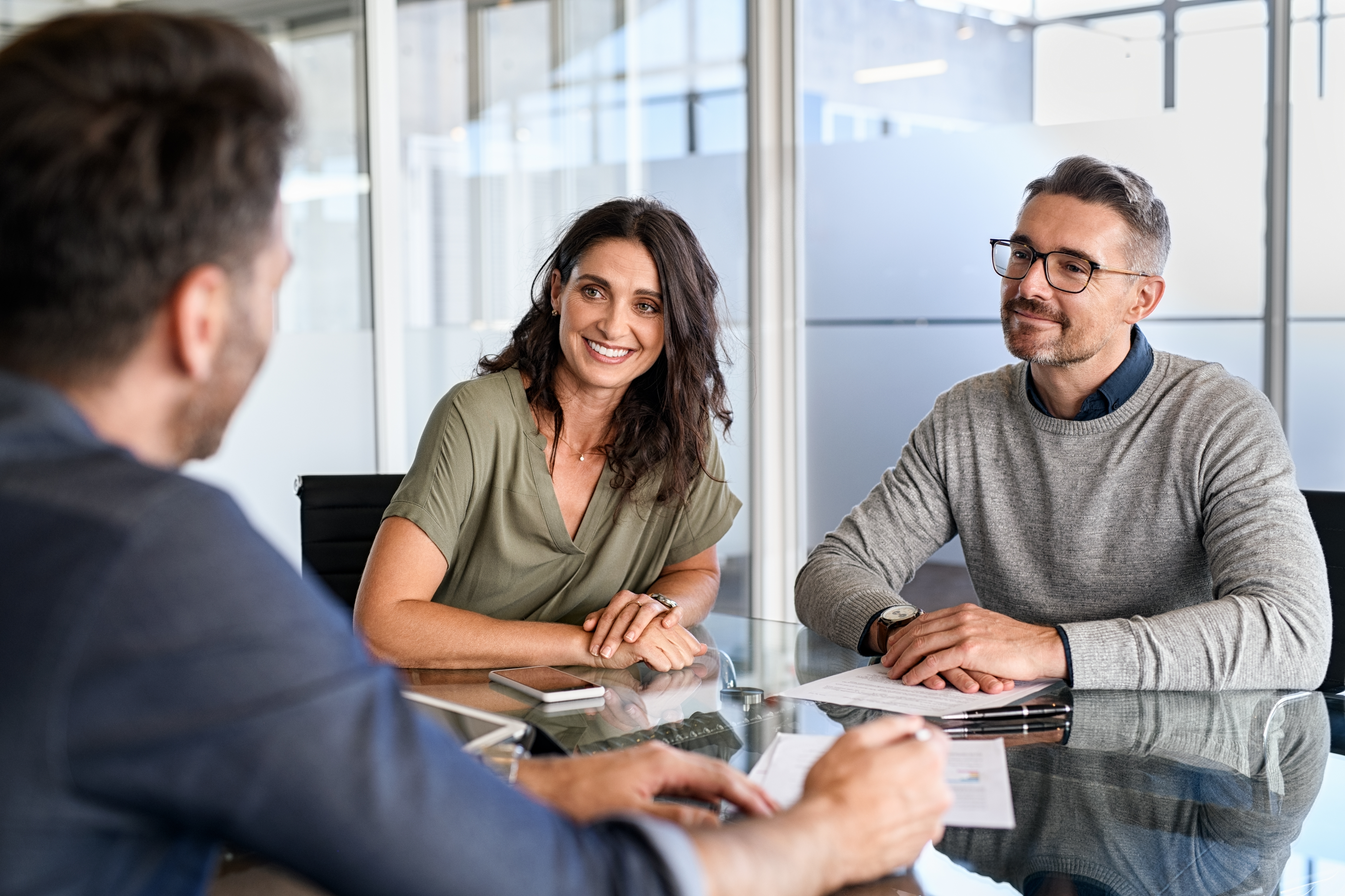 people making a deal at the mortgage table.