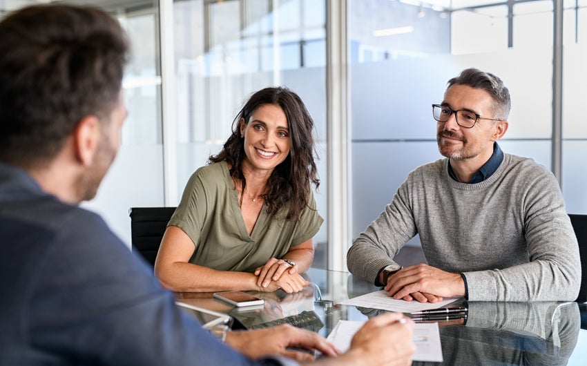 people making a deal at the mortgage table.