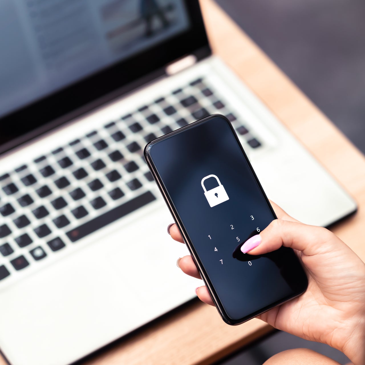An image of a person holding a padlock.