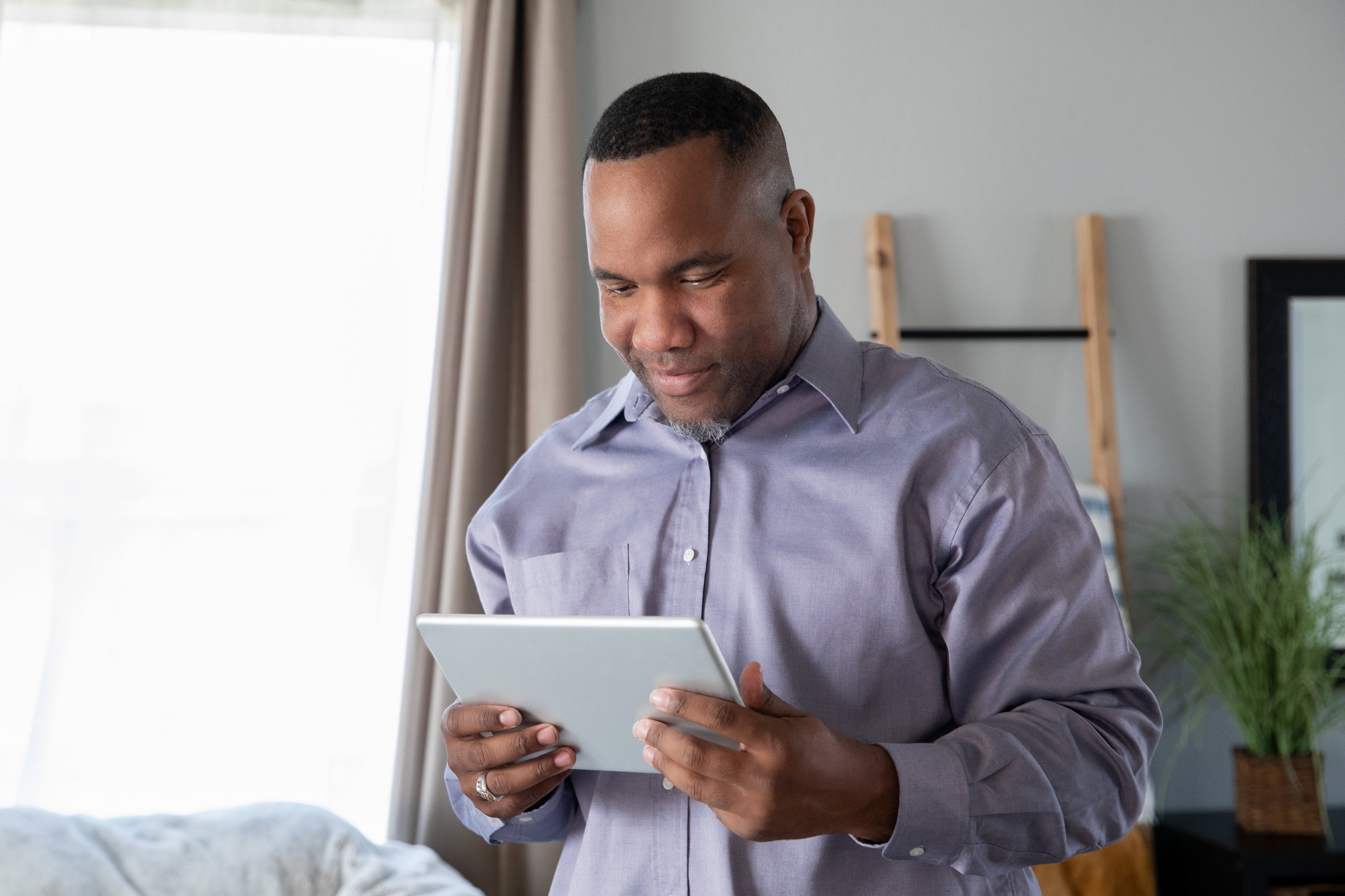 man holding an ipad
