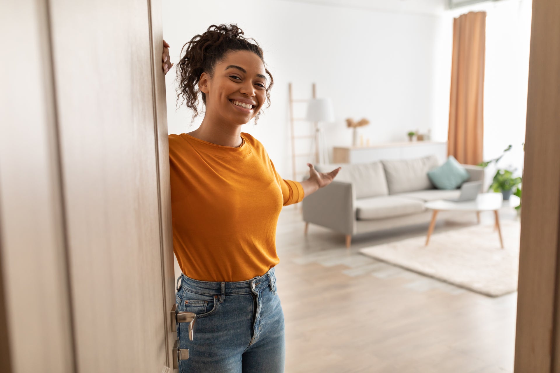 Gen Z woman opening the door to her home