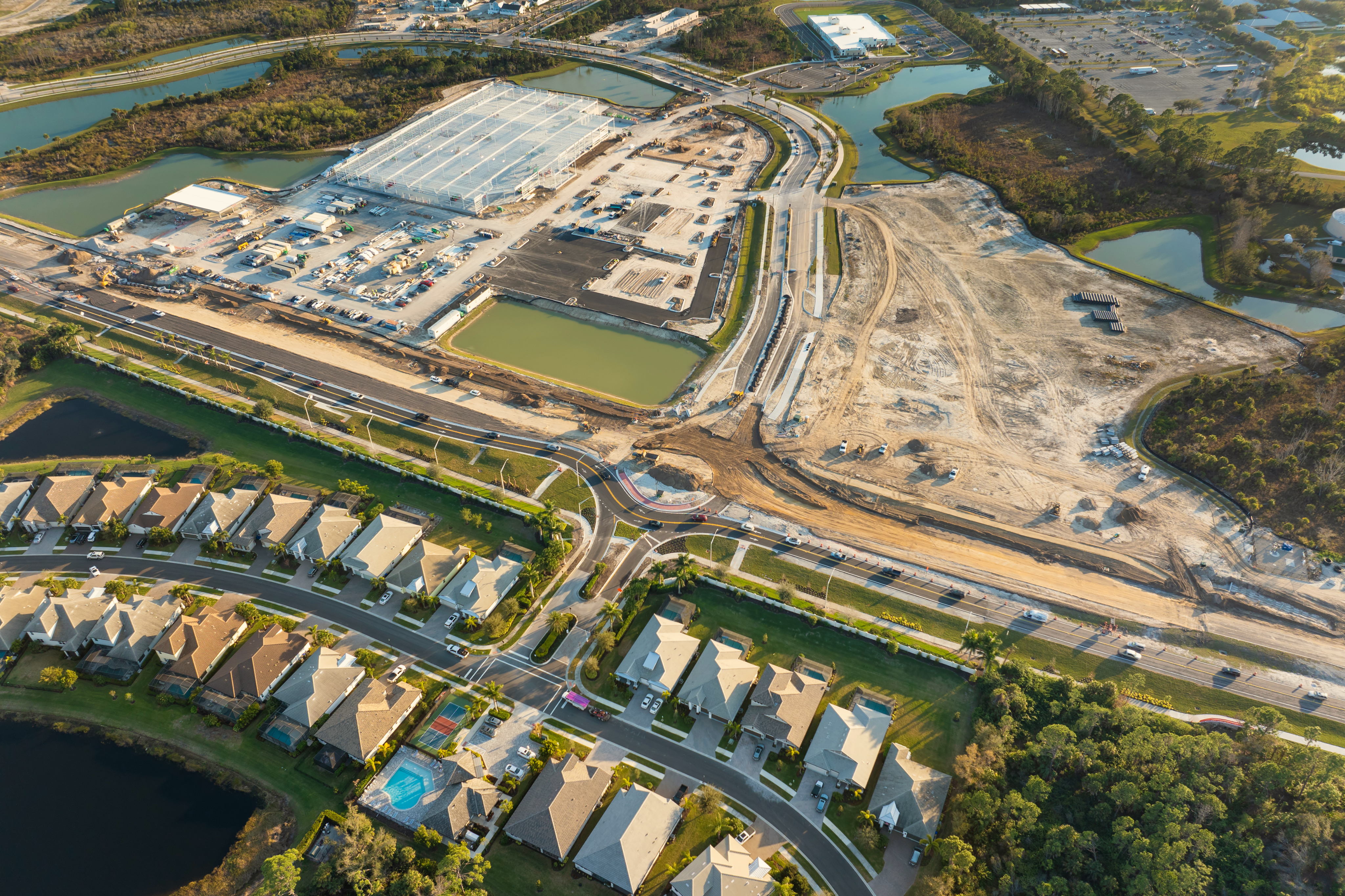 Aerial view of countryside set up with residential locality and factories around.