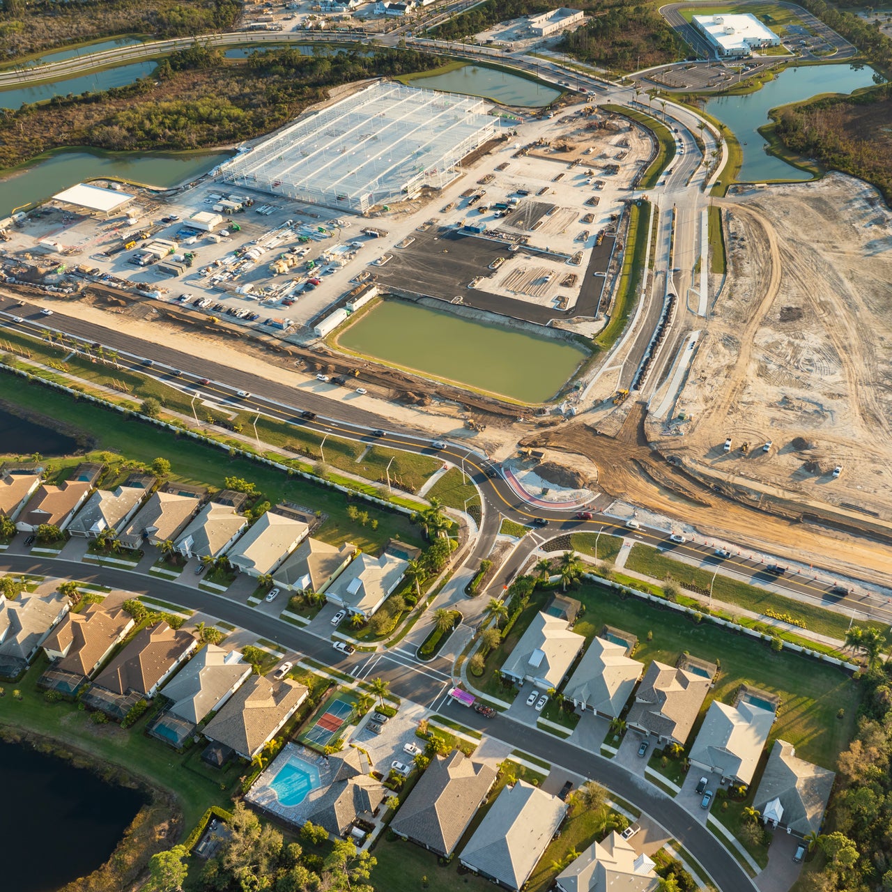 Aerial view of countryside set up with residential locality and factories around.