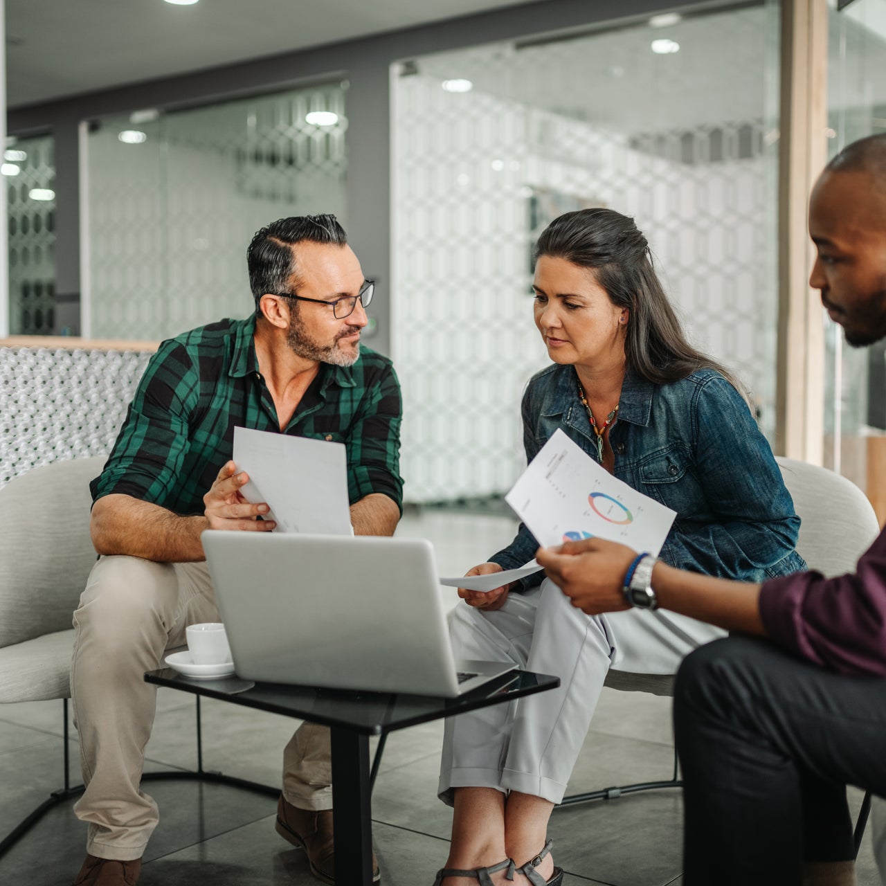 A group of colleagues looking at a laptop
