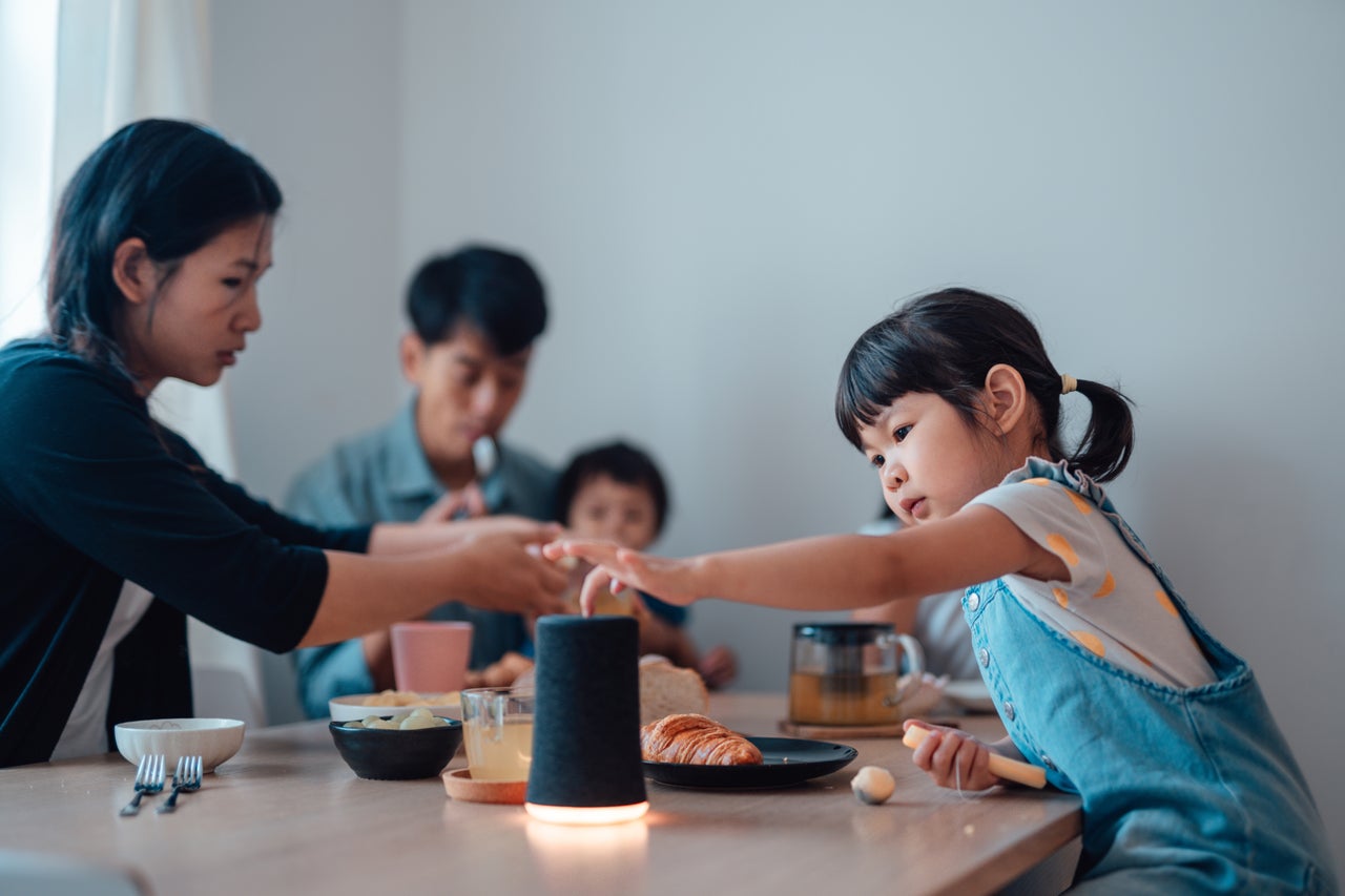 Little girl at the table touching AI powered light