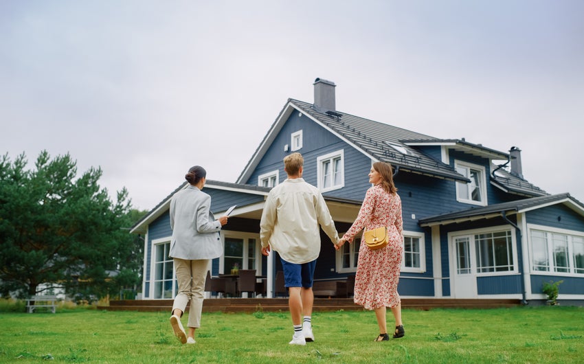 Young homebuyers walking into their new home.