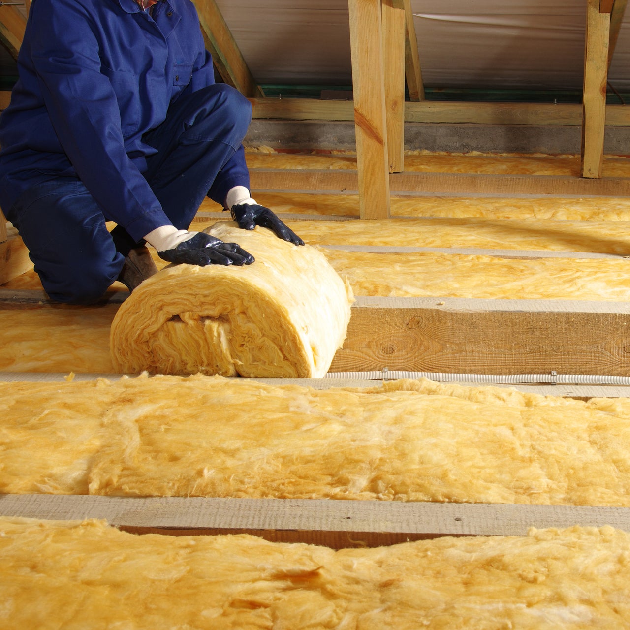 Contractor rolling up insulation