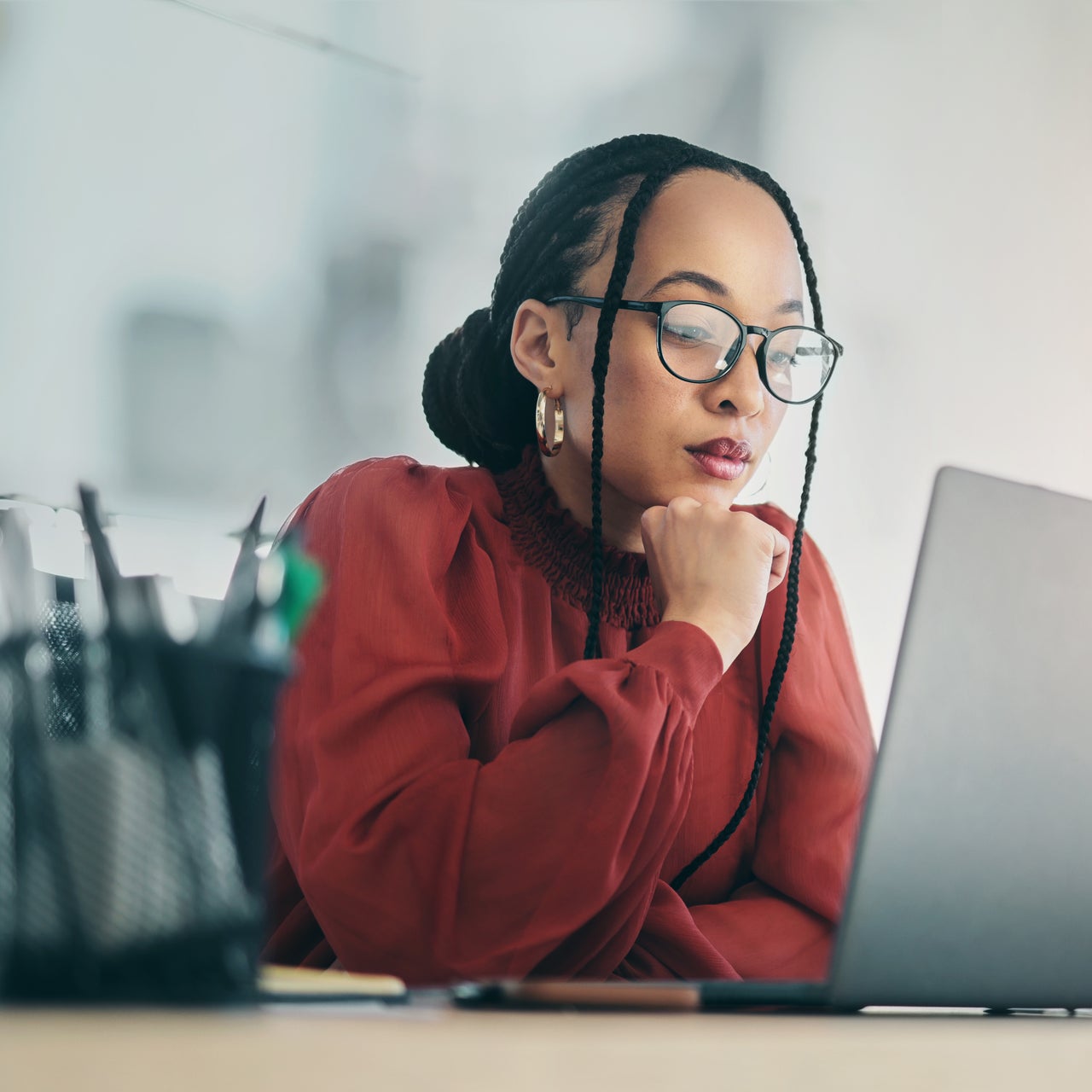 A woman looking at her laptop.