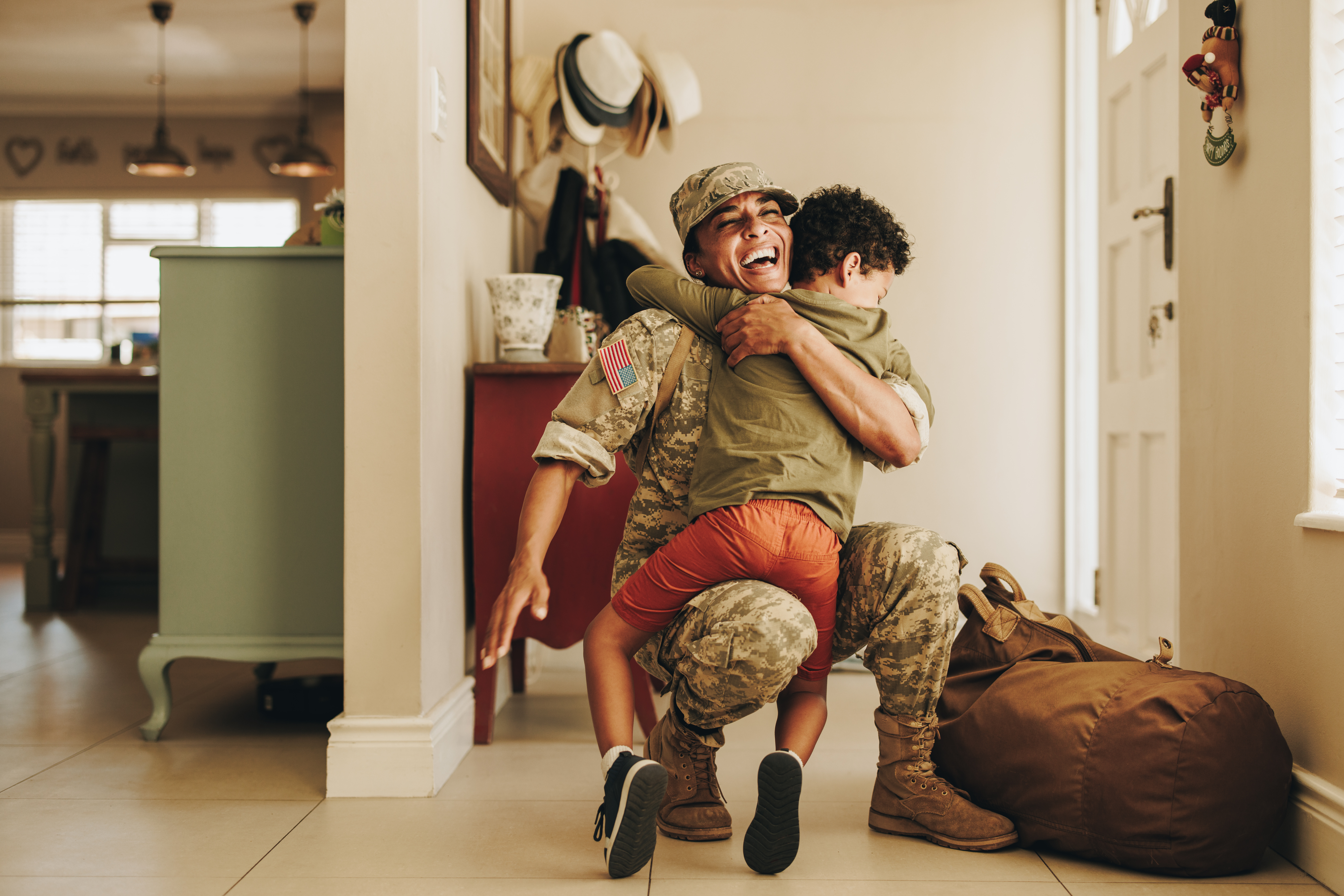 A military member hugging a child