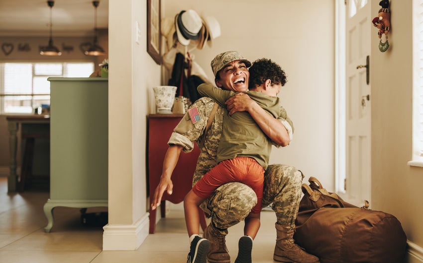 A military member hugging a child