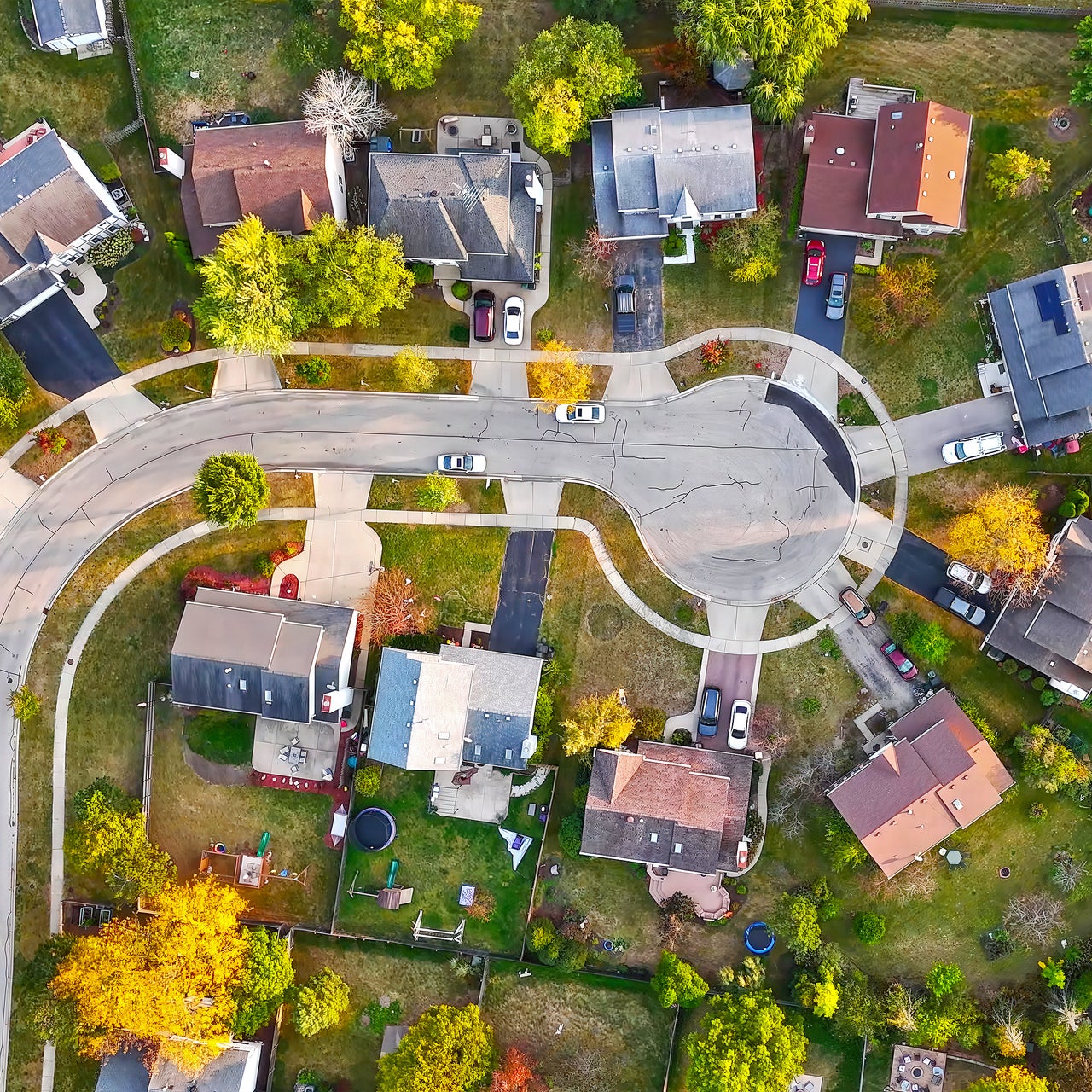 An aerial view of a suburban neighborhood with trees.