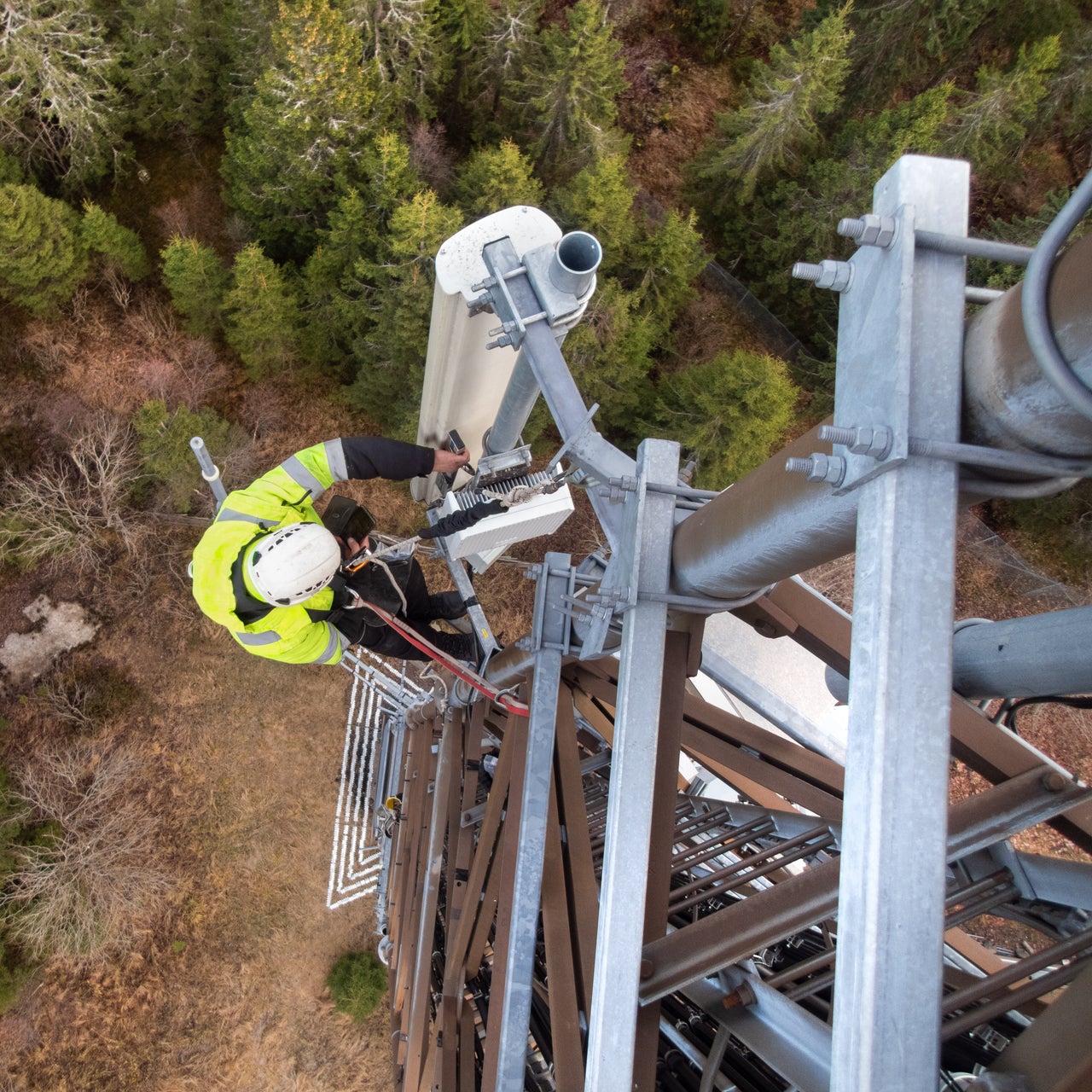 A worker climbing up a telecommunication tower to fix some glitch.