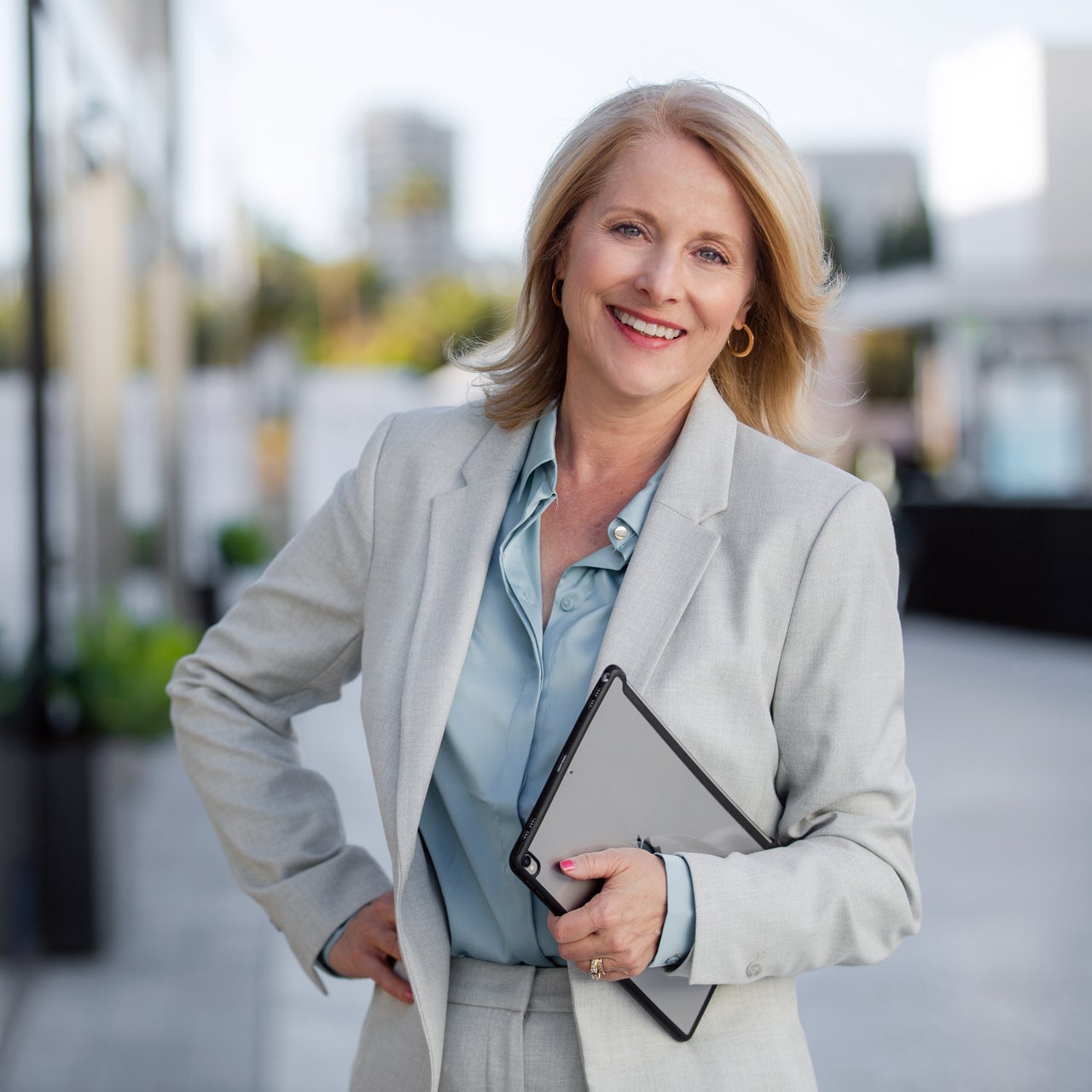 Real estate agent standing confidently and smiling