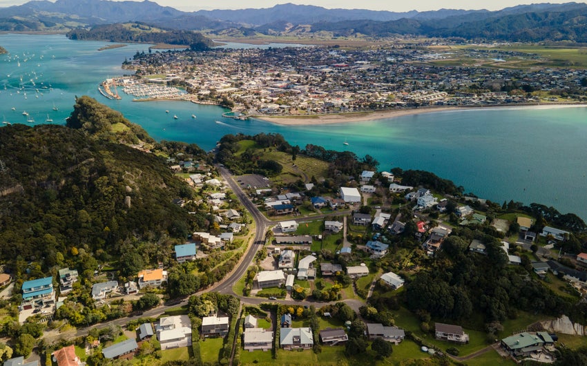 aerial view of buildings next to a body of water