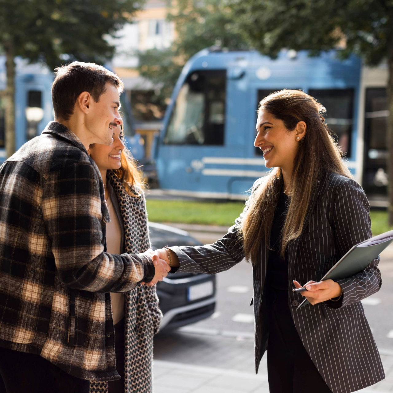 Real estate agent shaking hands with homeowners