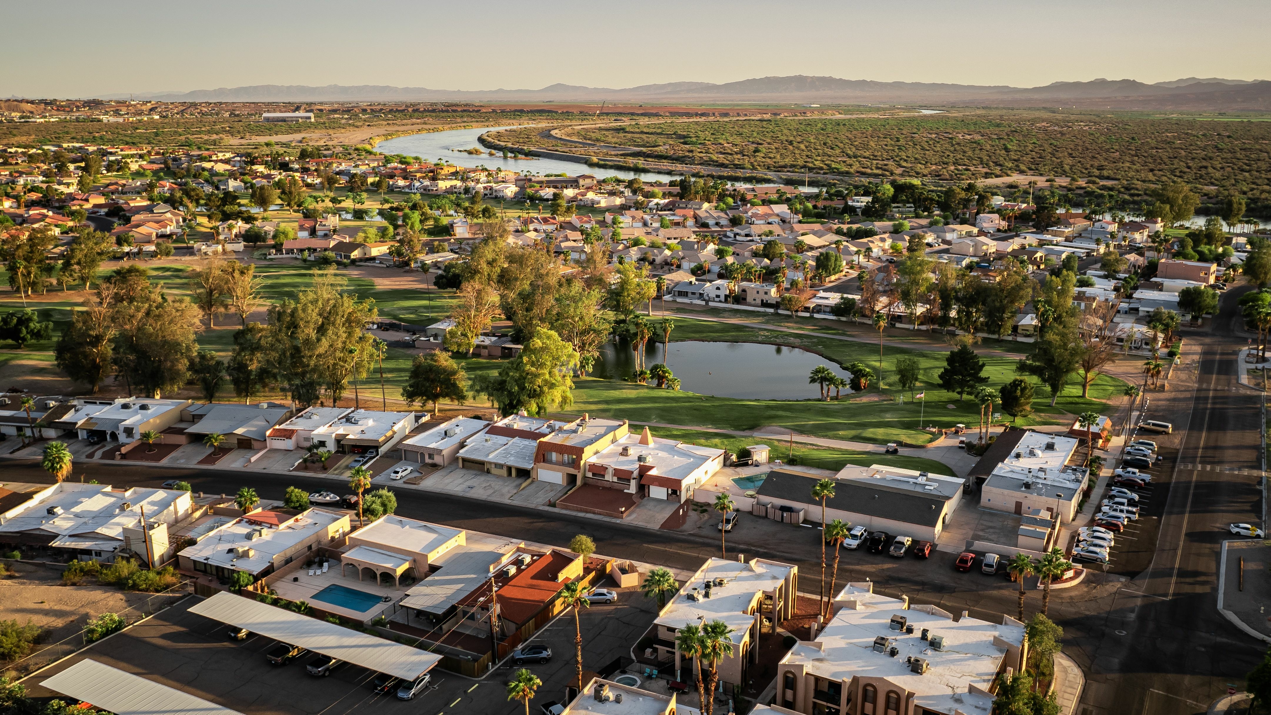 Aerial view of a residential areas with mountains in the background.