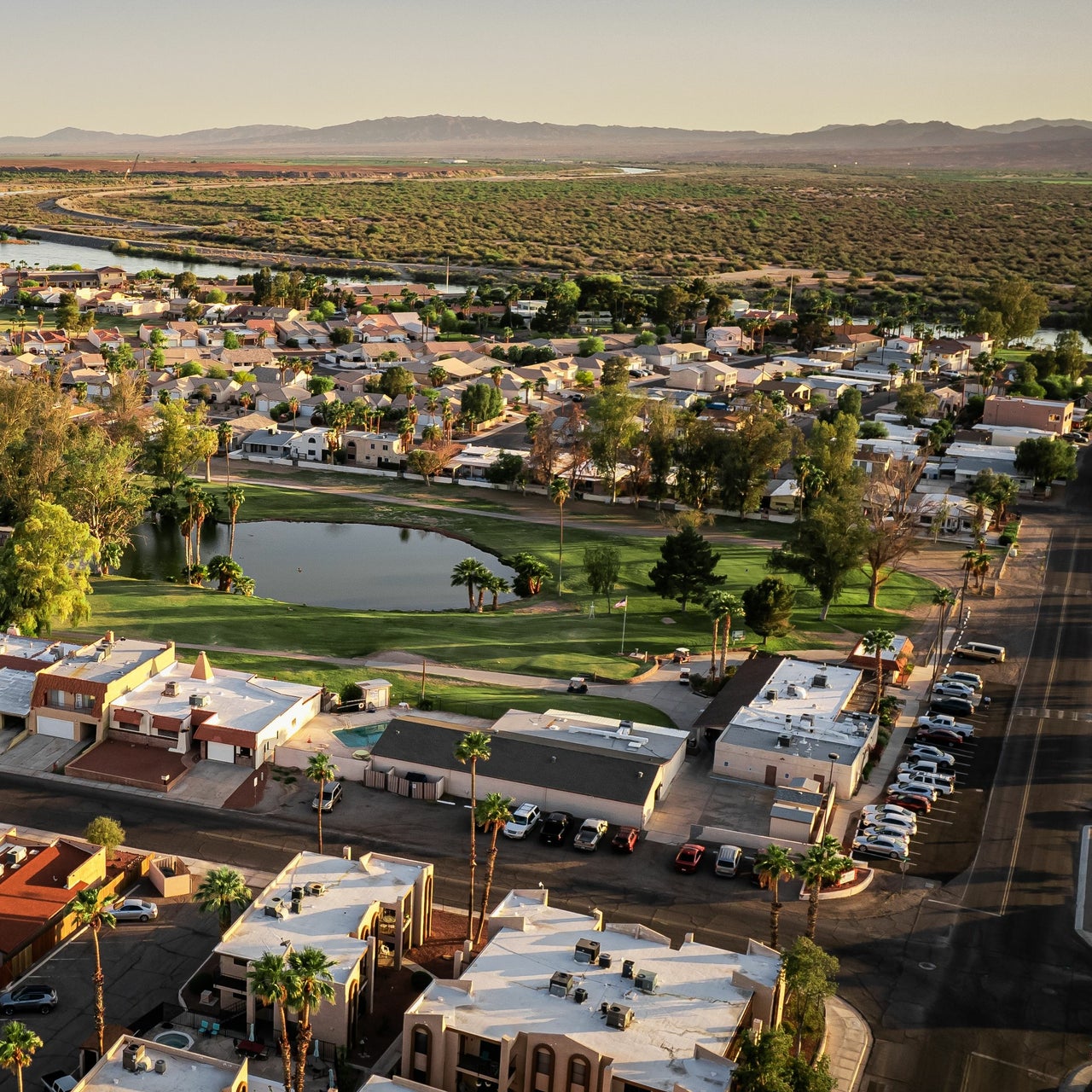 Aerial view of a residential areas with mountains in the background.