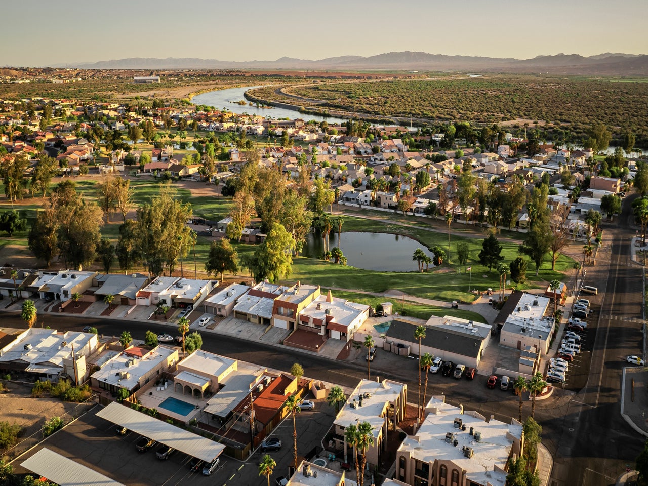 Aerial view of a residential areas with mountains in the background.