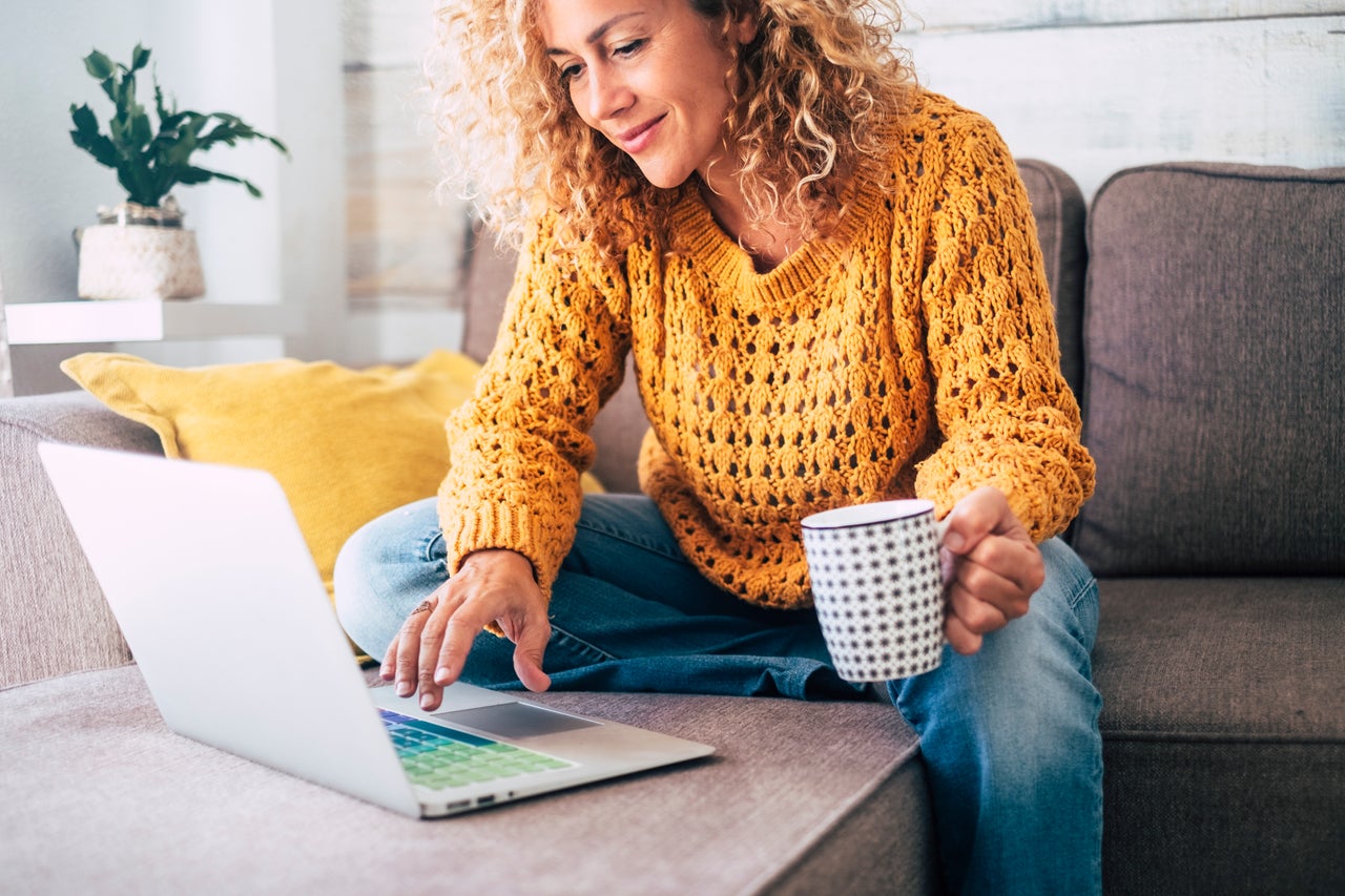 woman on couch in home with coffee