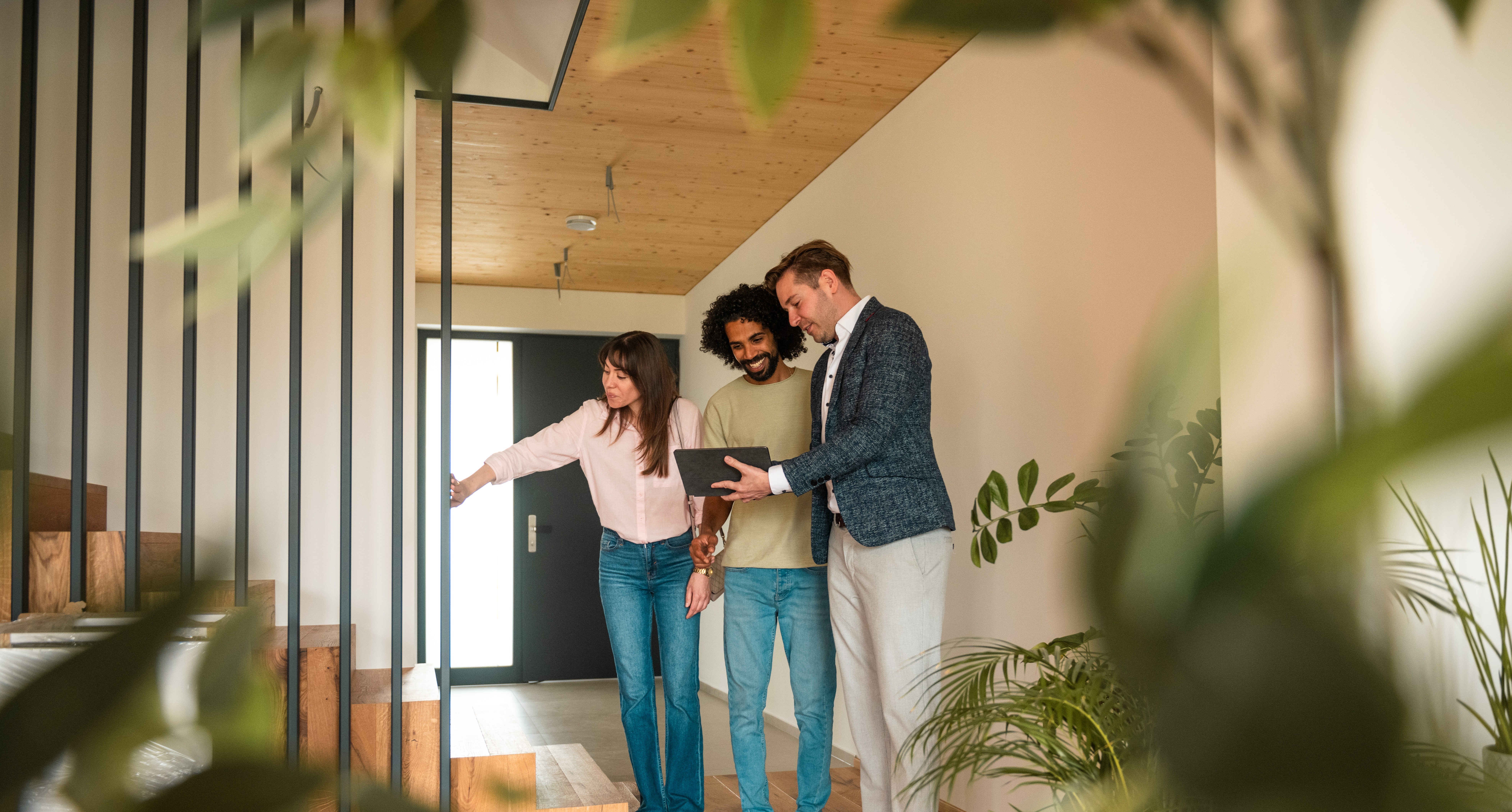 Real estate agent showing a couple around a new home