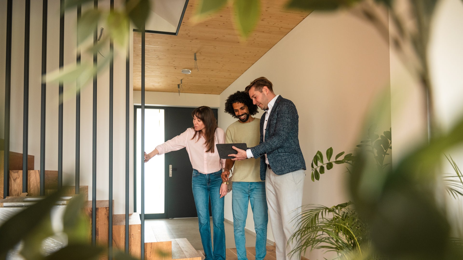 Real estate agent showing a couple around a new home