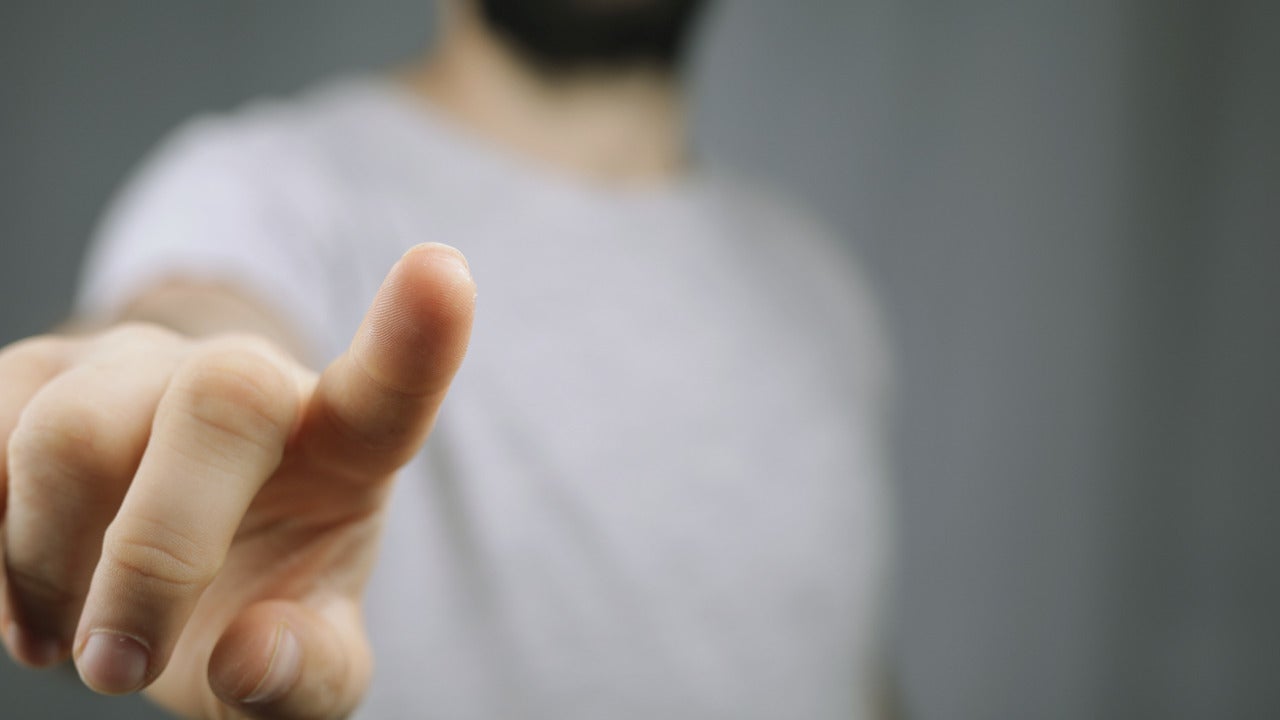 A person clicking a screen