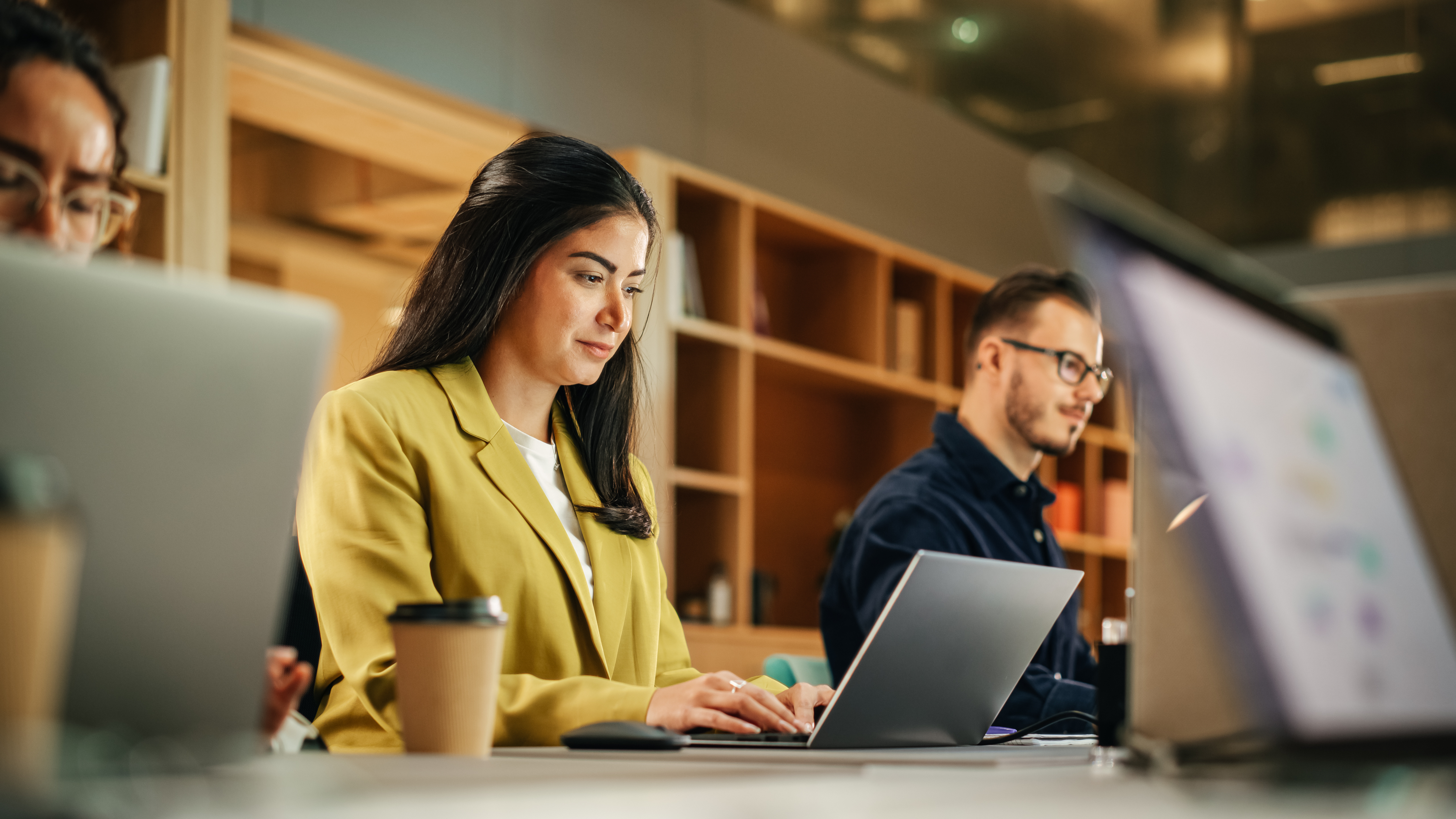 Three people working on their laptops