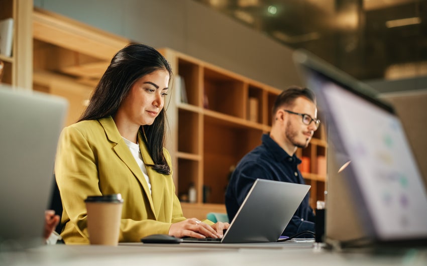 Three people working on their laptops
