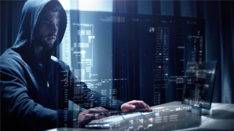 Someone who is supposed to look like a hacker, working on a computer