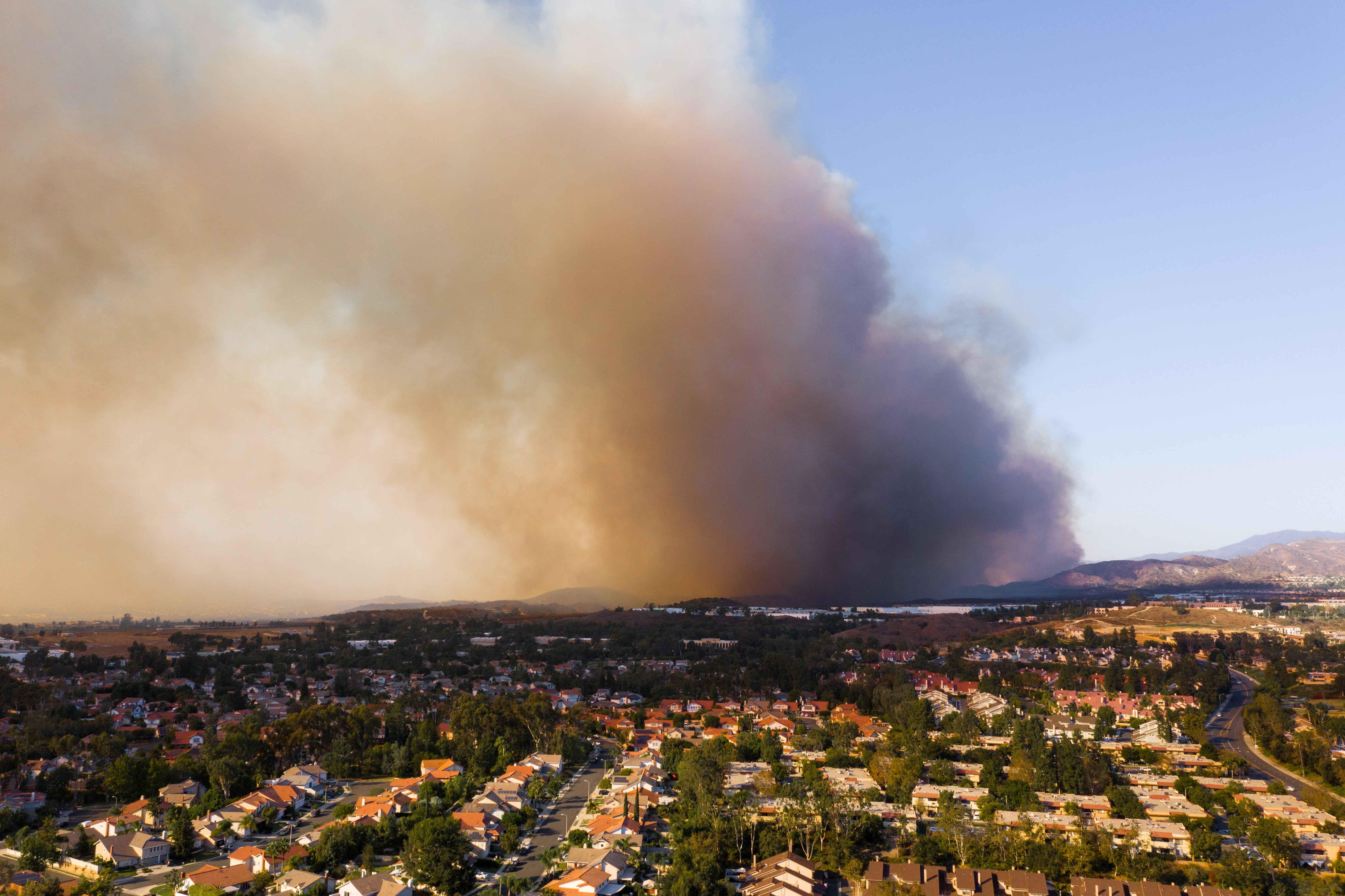 California wilderness scenery with wildfire burning in the distance