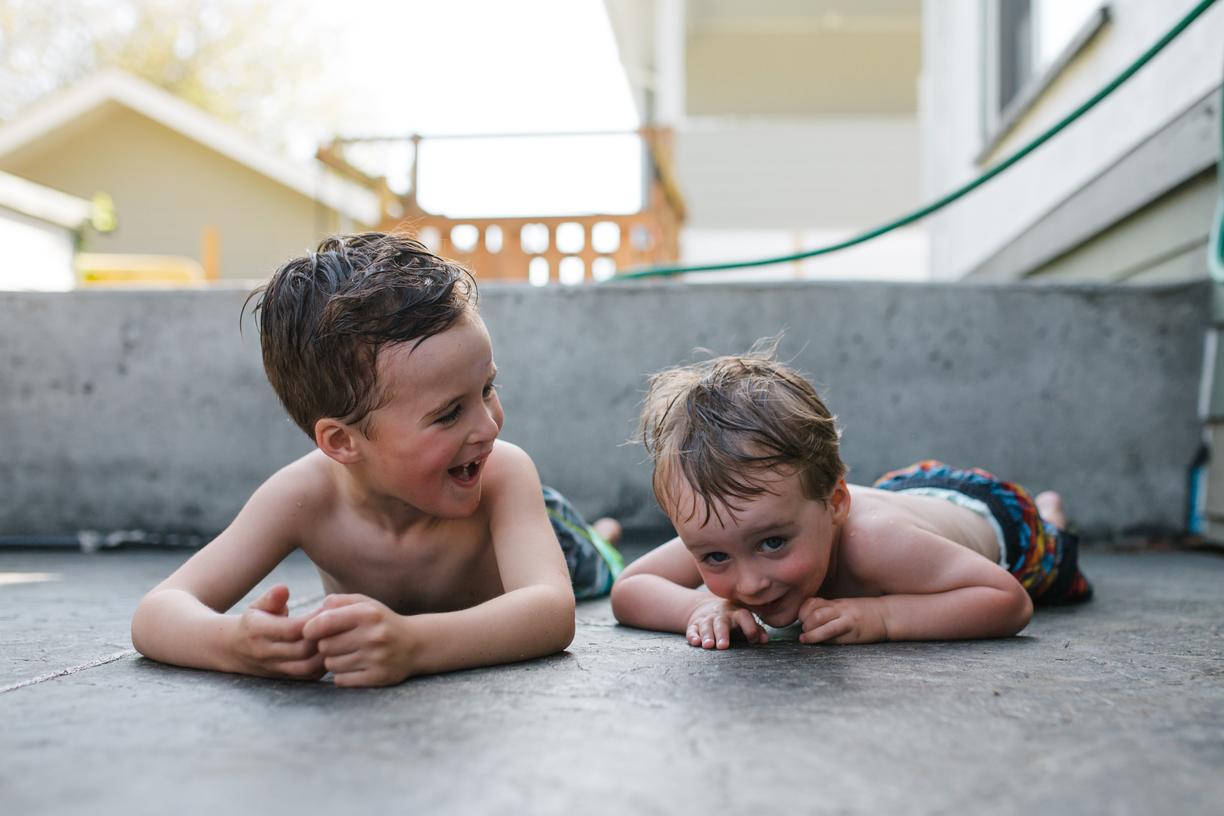 Two toddlers looking at each other in cheerful mood.