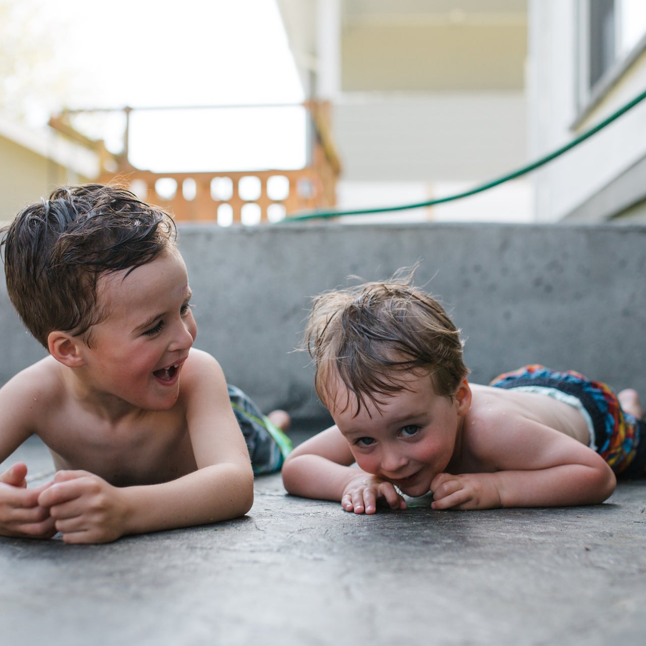 Two toddlers looking at each other in cheerful mood.