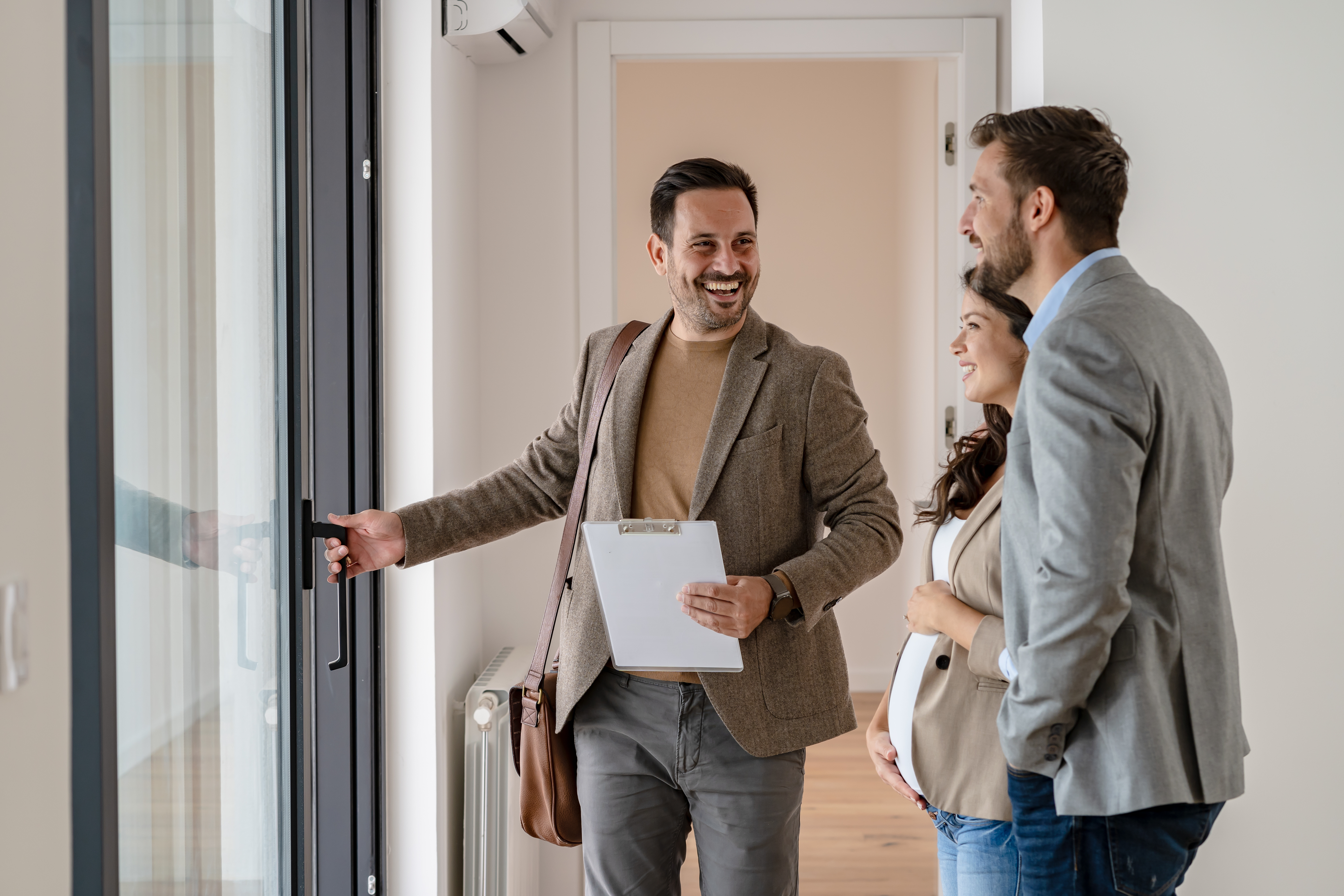 A real estate agent showing a couple around