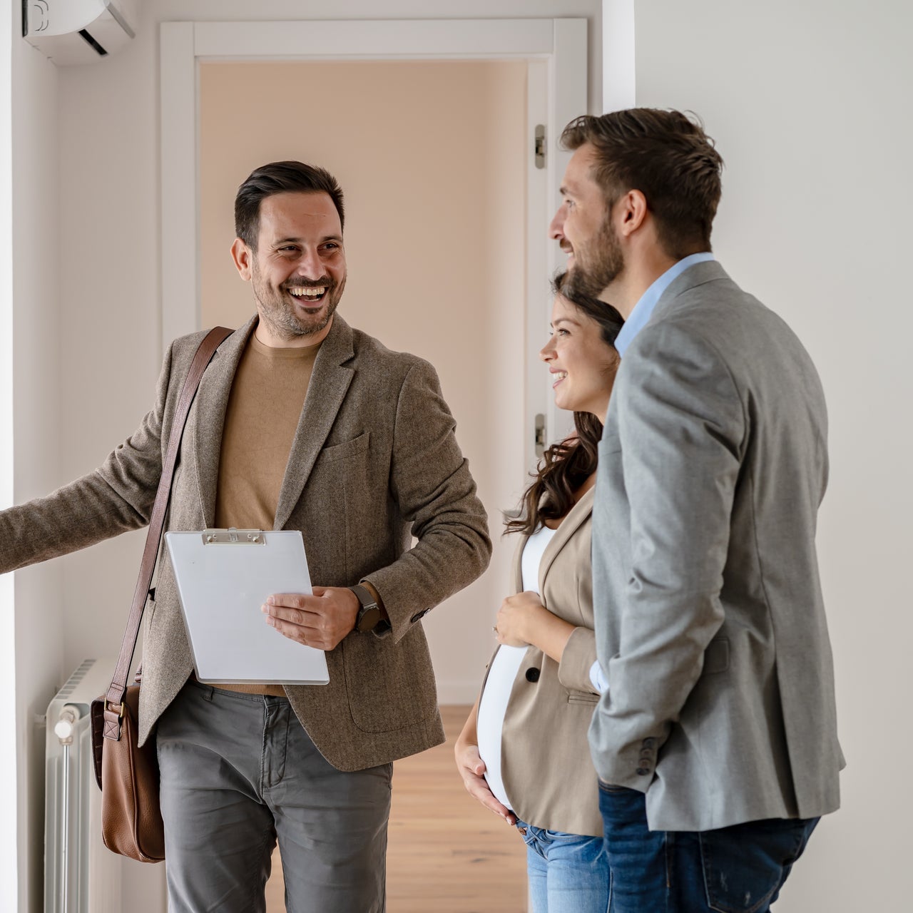 A real estate agent showing a couple around