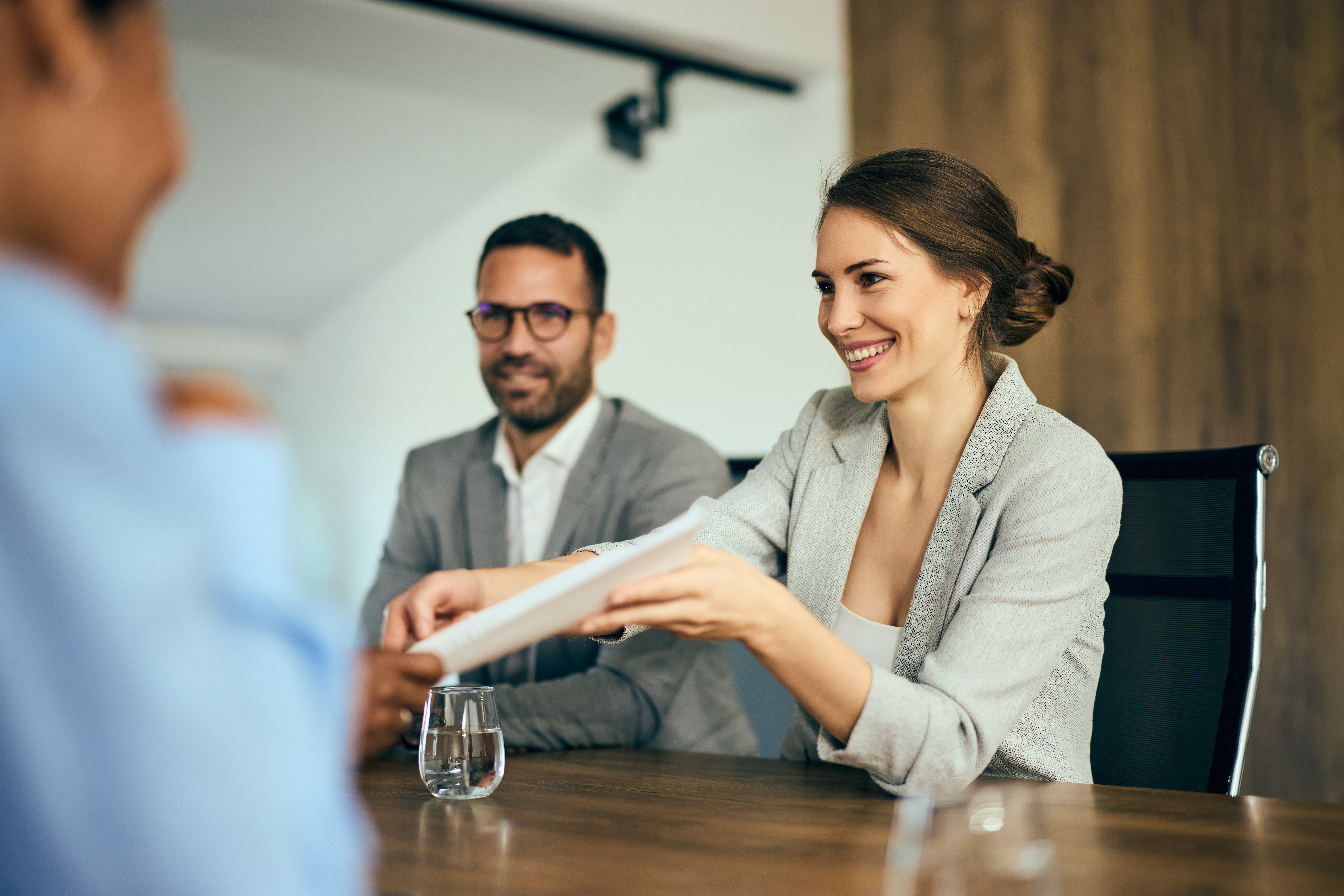 A couple sitting across the table with a real estate agent. 