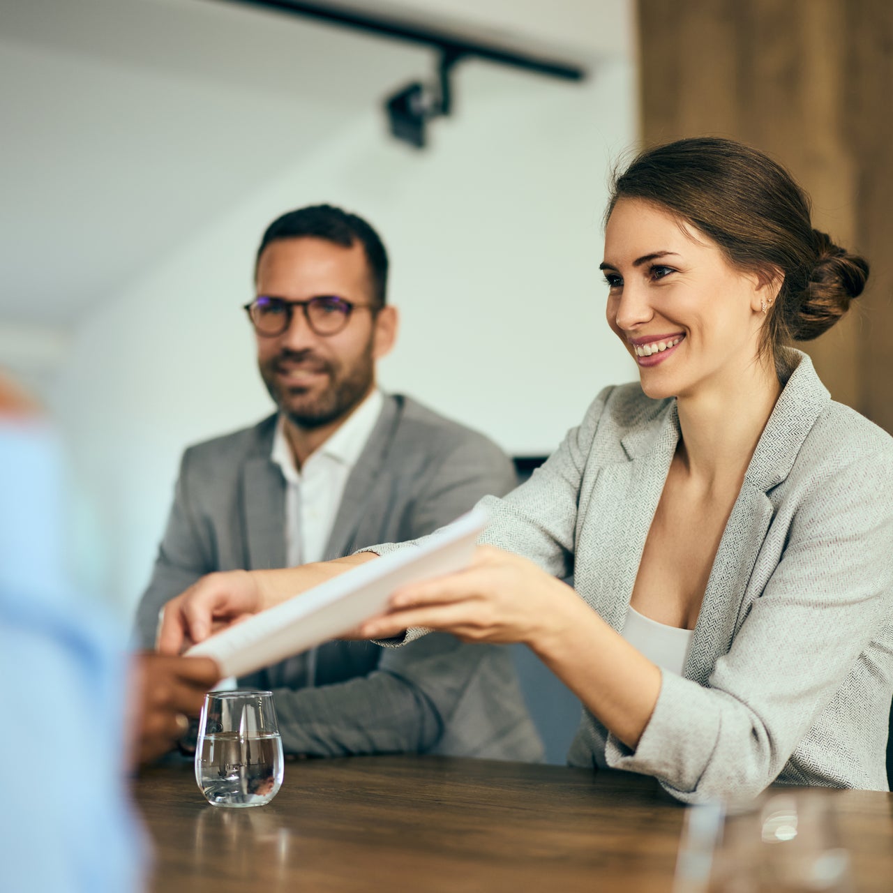 A couple sitting across the table with a real estate agent.
